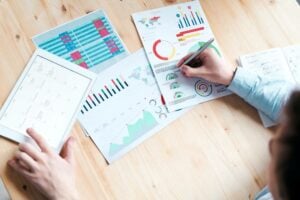 business person forecasting in business by looking over charts at a desk 