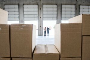 an inventory financing company in a warehouse looking at boxes of inventory