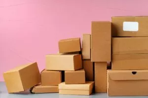 a pile of boxes against a pink background that was bought from an inventory loan