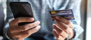 a customer searching on their smartphone is stripe safe and then buying items while holding a credit card