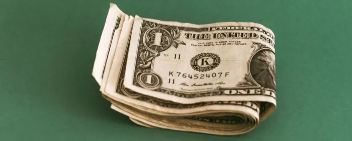 Dollar bills folded on a green table