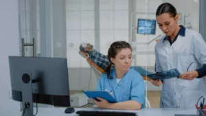 a couple of dentists looking up the pllc meaning while a patient waits in the background