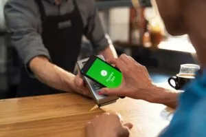 a customer paying on a terminal using their phone after a merchant decided between authorize.net vs stripe