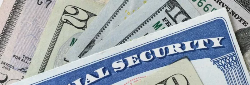social security card and pile of dollar bills symbolizing the occurrence of ACH return code R41