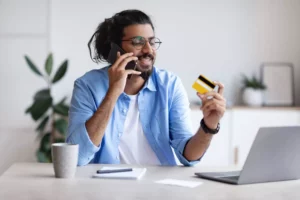 a customer on the phone looking at his credit card asking about a voice authorization fee