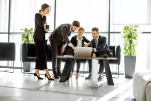 A group of bank tellers gathered around to show how to verify a cashier's check