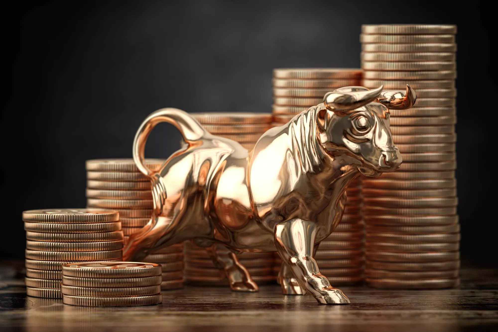 toy bull surrounded with coins