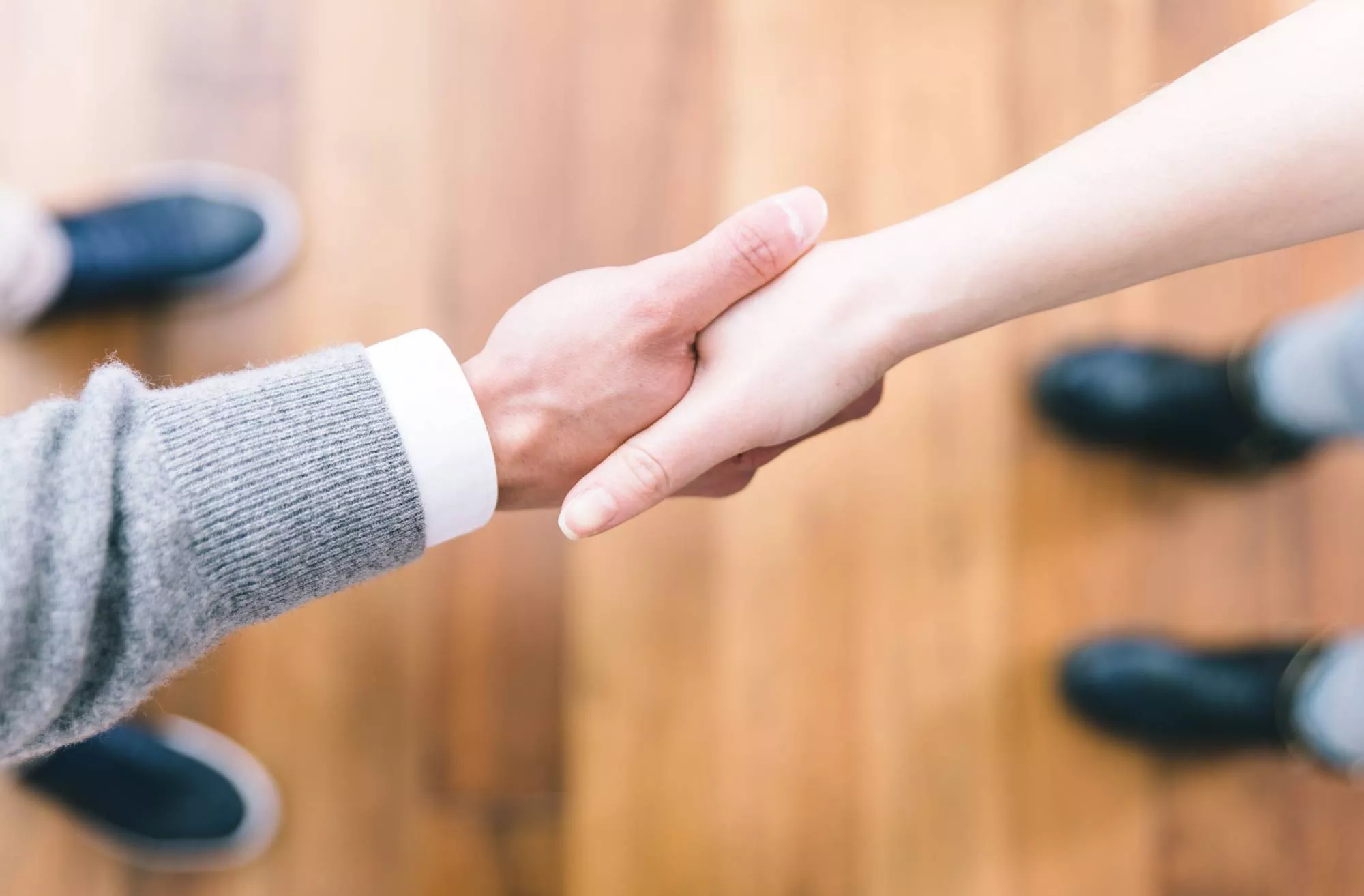 business people shaking hands agreeing on early termination fee