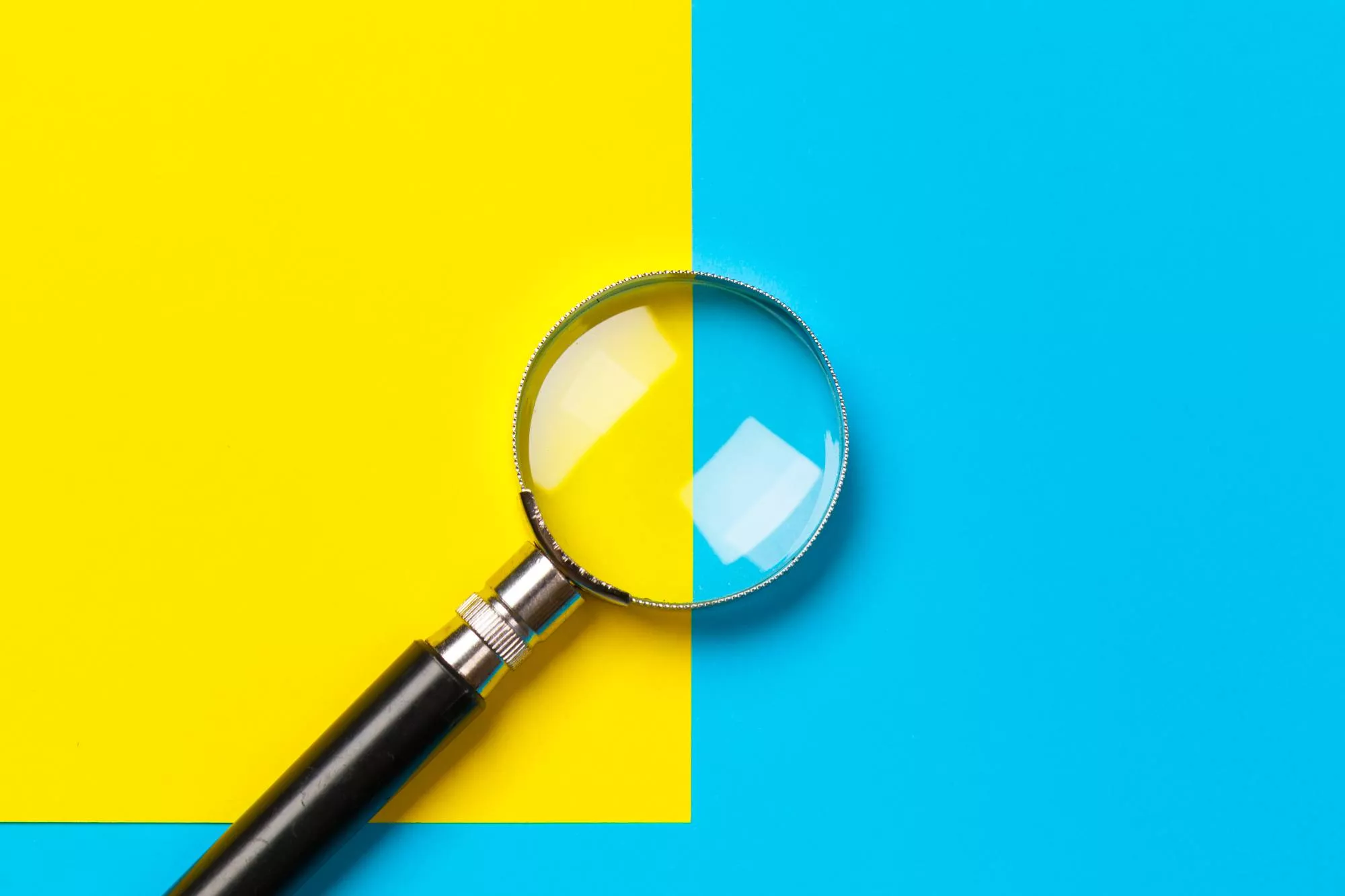 a maginifying glass on a blue and yellow background that will be used for check verification
