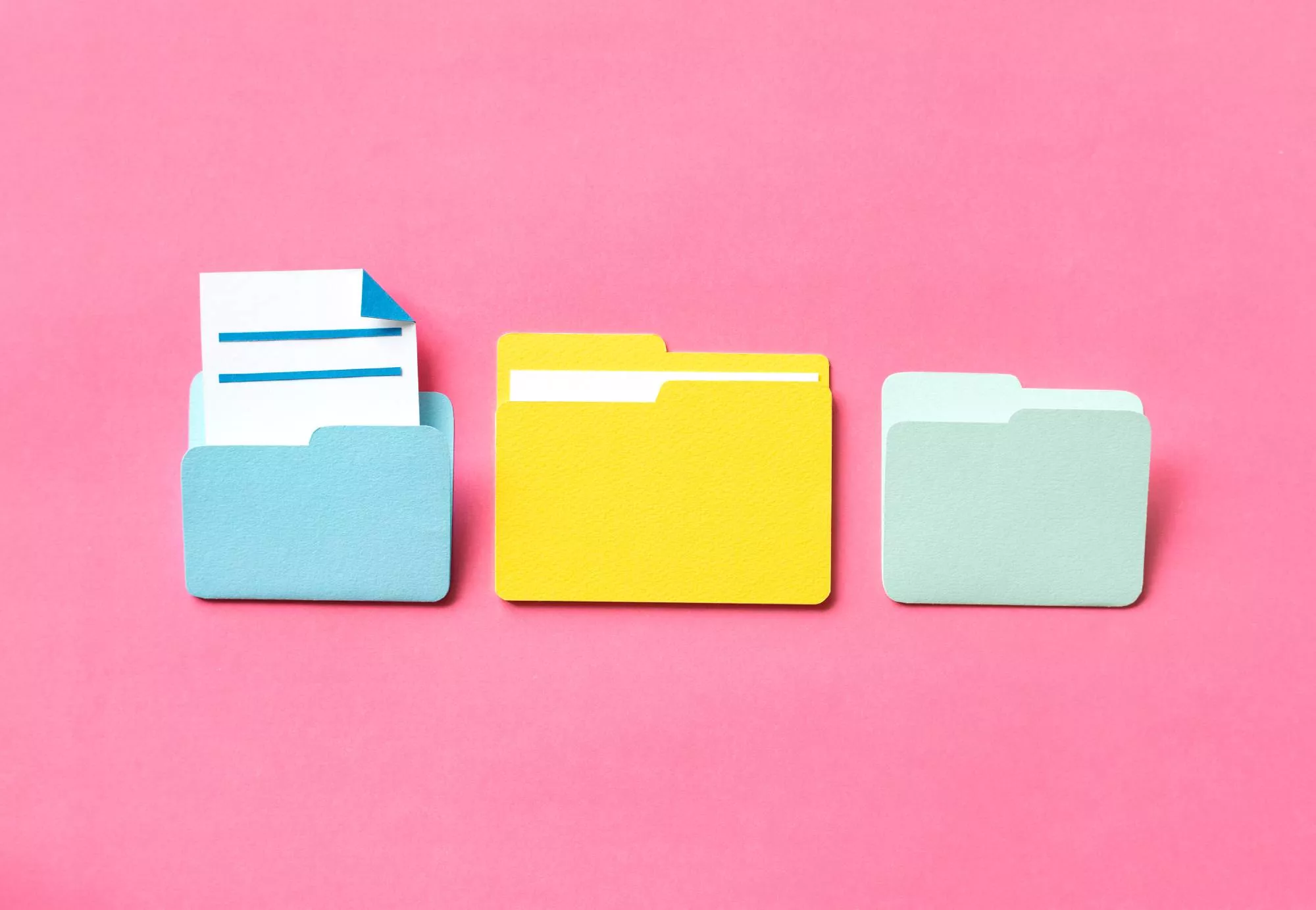 photo of three filing folders on a pink background with a ucc filing document sticking out