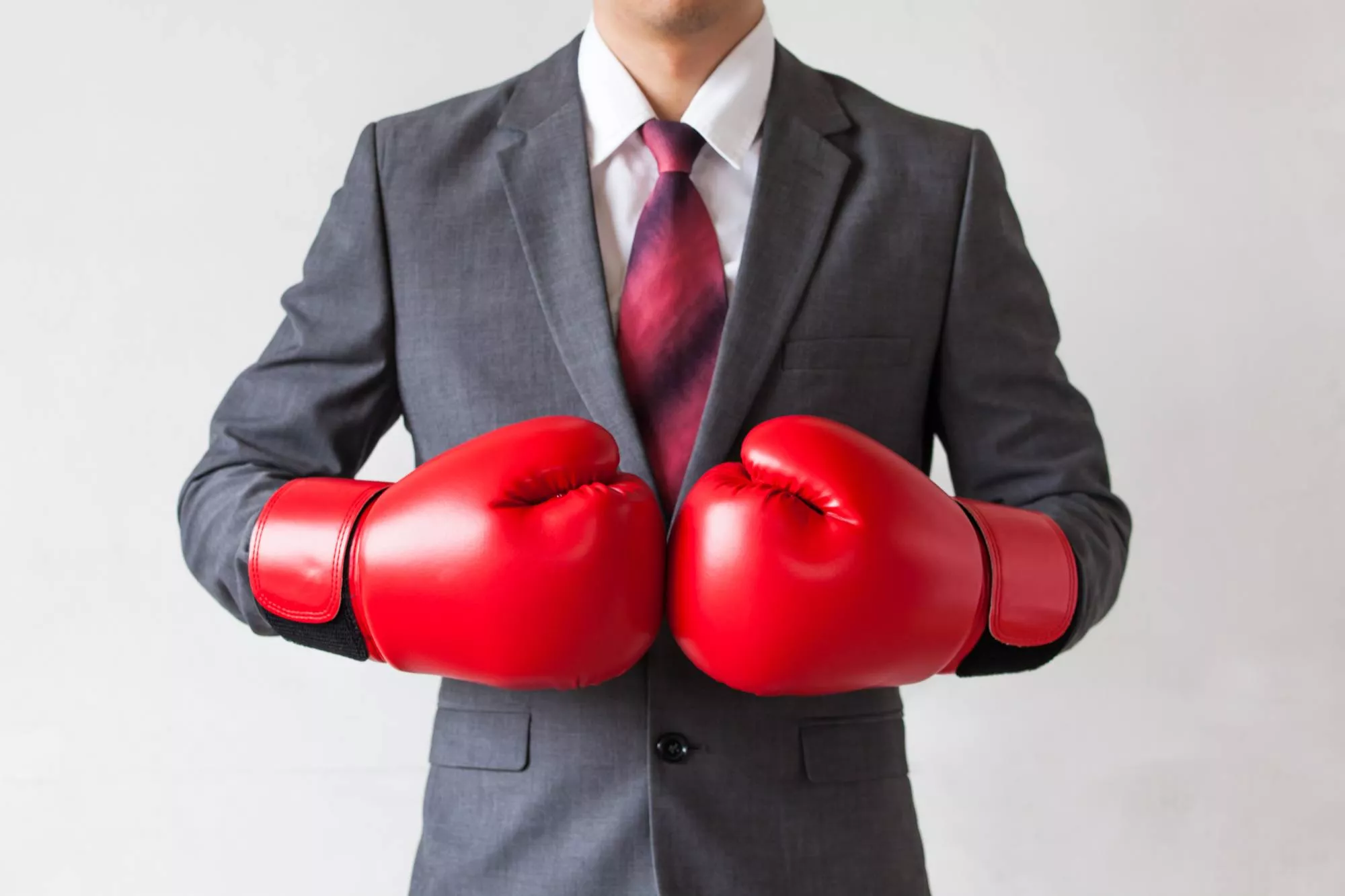 a businessman in a suit with boxing gloves to fight a chargeback dispute