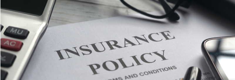 picture of an insurance policy on a desk to represent chargeback insurance for merchants