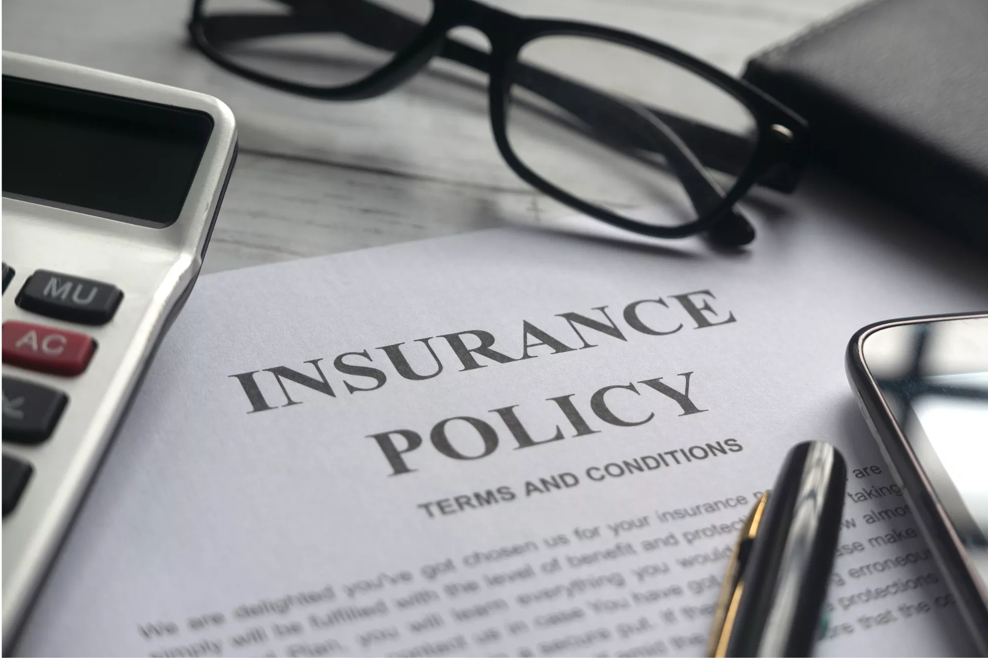 picture of an insurance policy on a desk to represent chargeback insurance for merchants