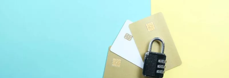 image of three credit cards with a lock on top on a blue and yellow background to show the security of a signature panel code
