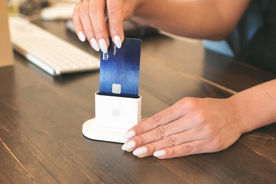 photo of the shopify card reader with someone inserting a credit card to show it is the best mobile reader