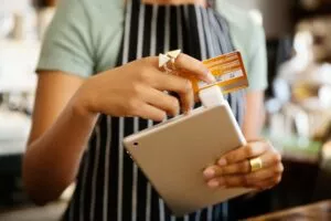 woman swiping credit card on tablet with a mobile card reader for an android 