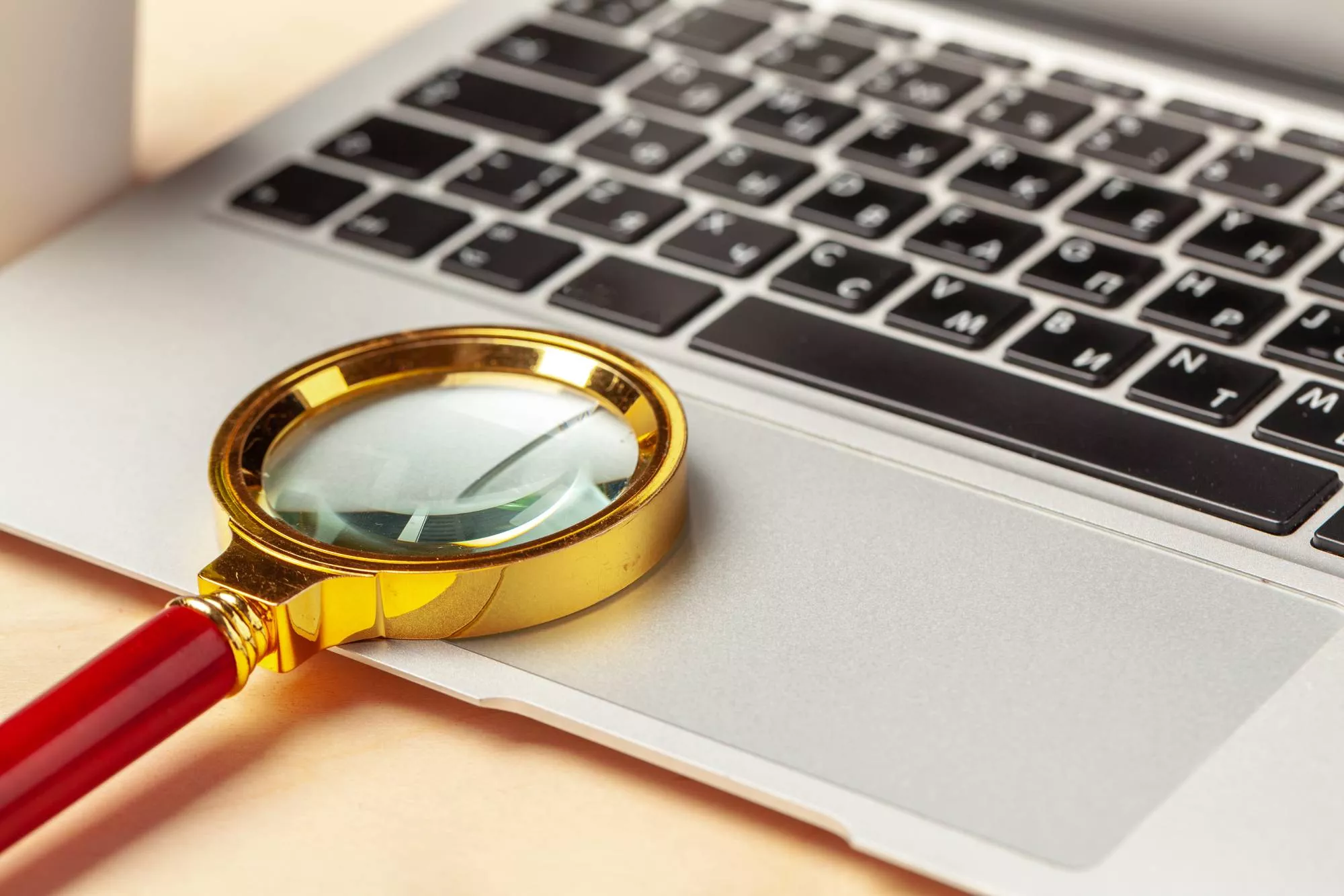 A magnifying glass on a laptop to find out what an R62 ACH return code is
