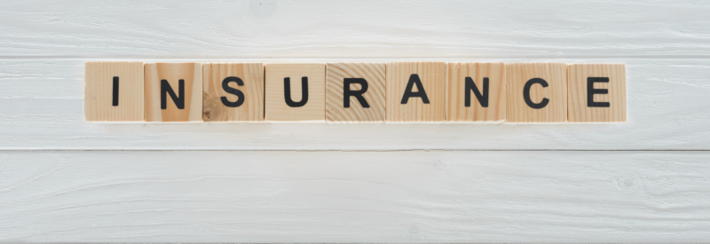 top view of business insurance word made of wooden blocks representing how to get business insurance