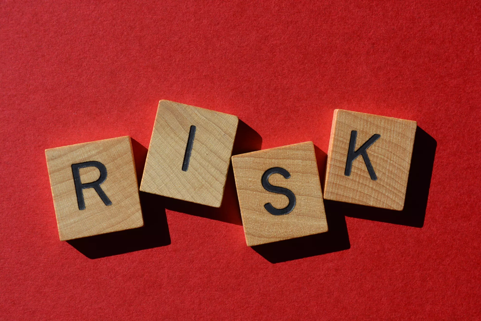 risk spelled with blocks on a red background for high-risk business