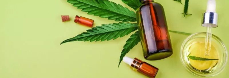 CBD products on a green background that a merchant can sell with Authorize.net CBD processing