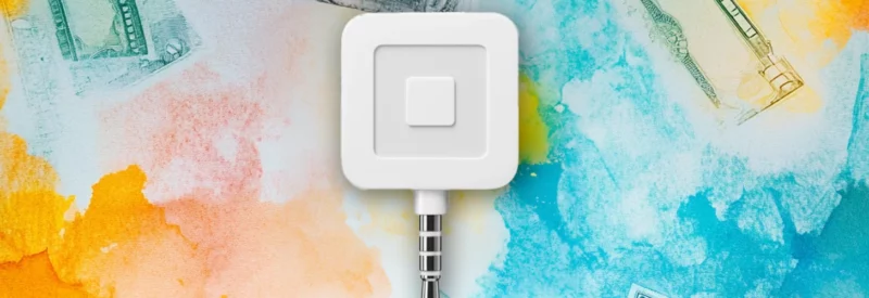 A Square card reader placed on a colorful watercolor background with subtle imagery of currency