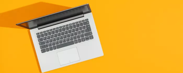 a laptop on a yellow background