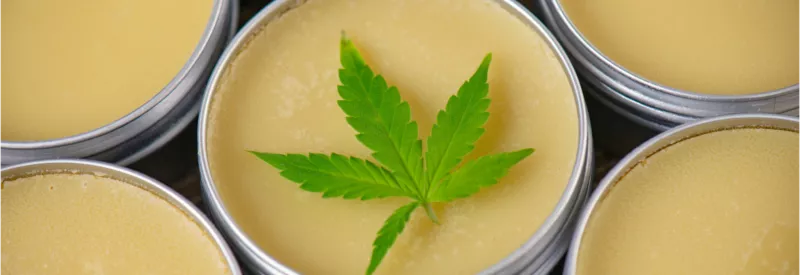 A cannabis leaf on top of CBD balm, one of the many CBD products impacted by the safe banking act