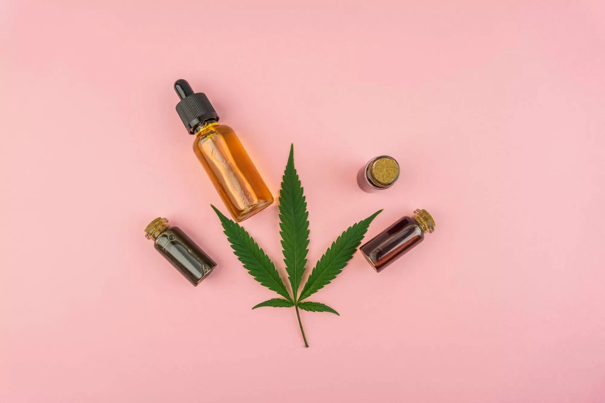 High-risk CBD products against a millennial pink background