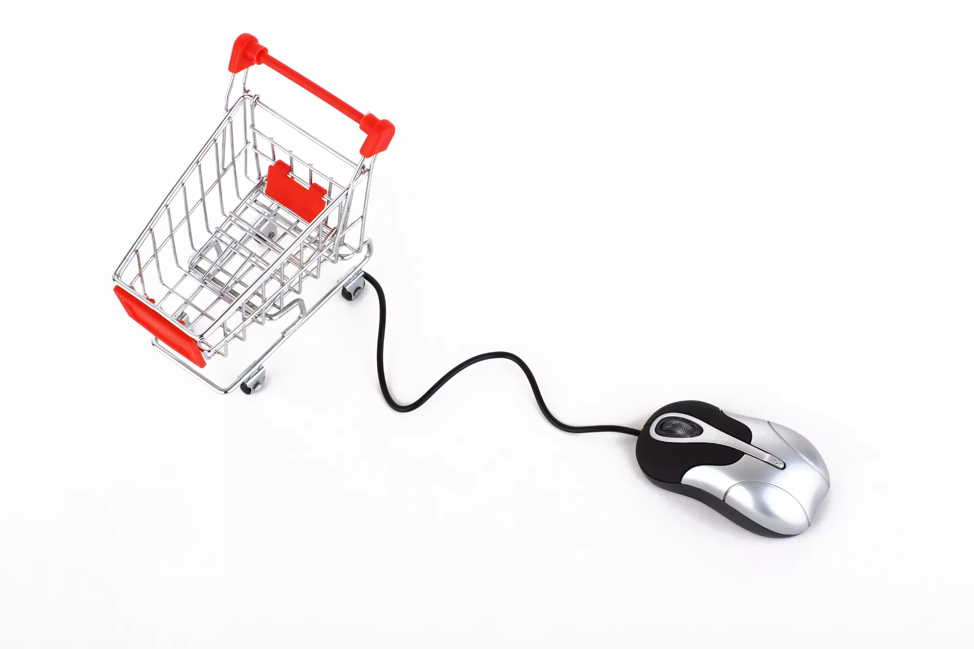 A shopping cart attached to a computer mouse moving to a computer with a bigcommerce gateway.