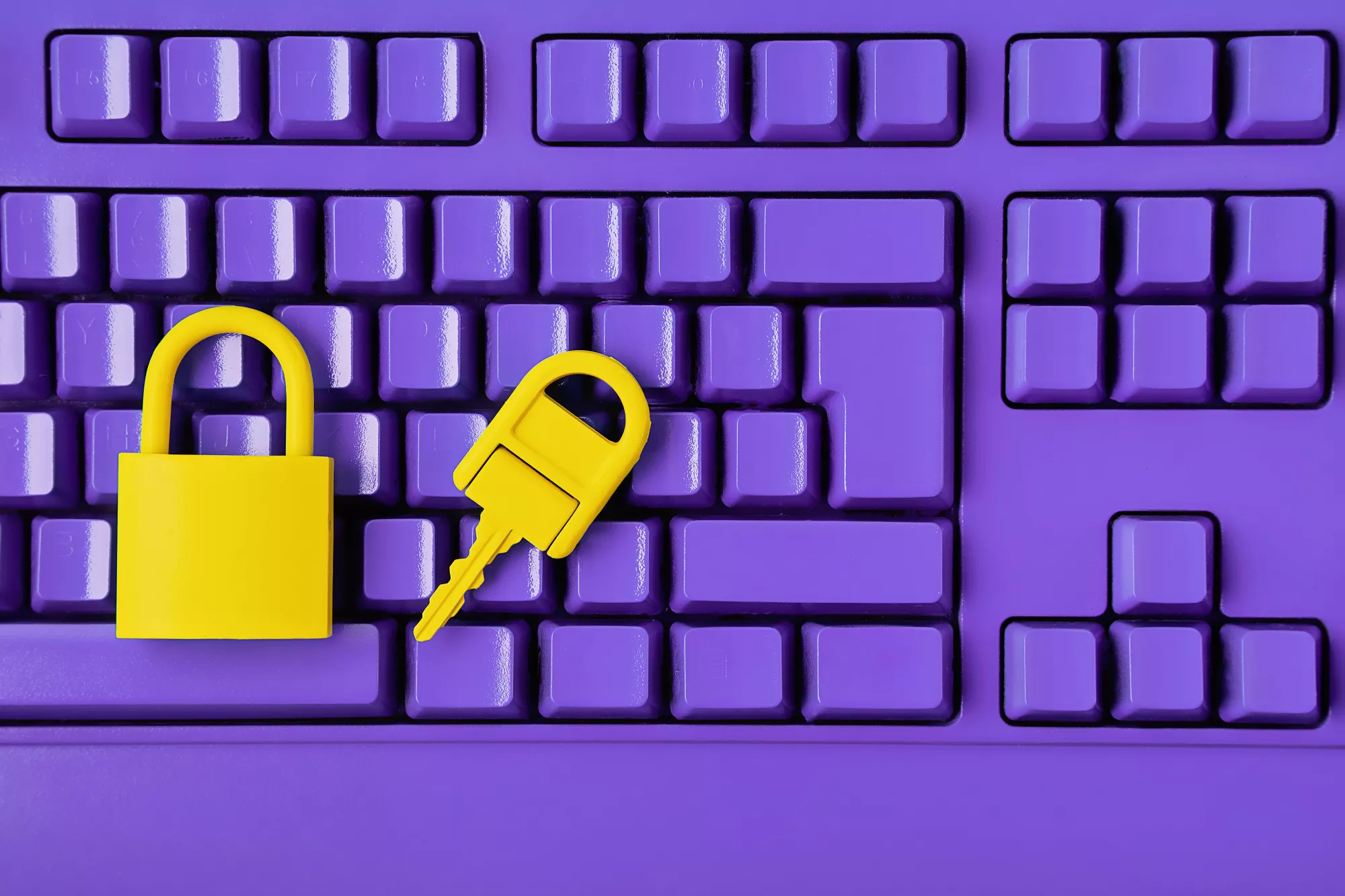 a purple computer keyboard with a yellow lock and key on it to represent a payment gateway