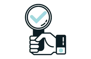 Hand holding a magnifying glass to look at IT ticketing system tips 