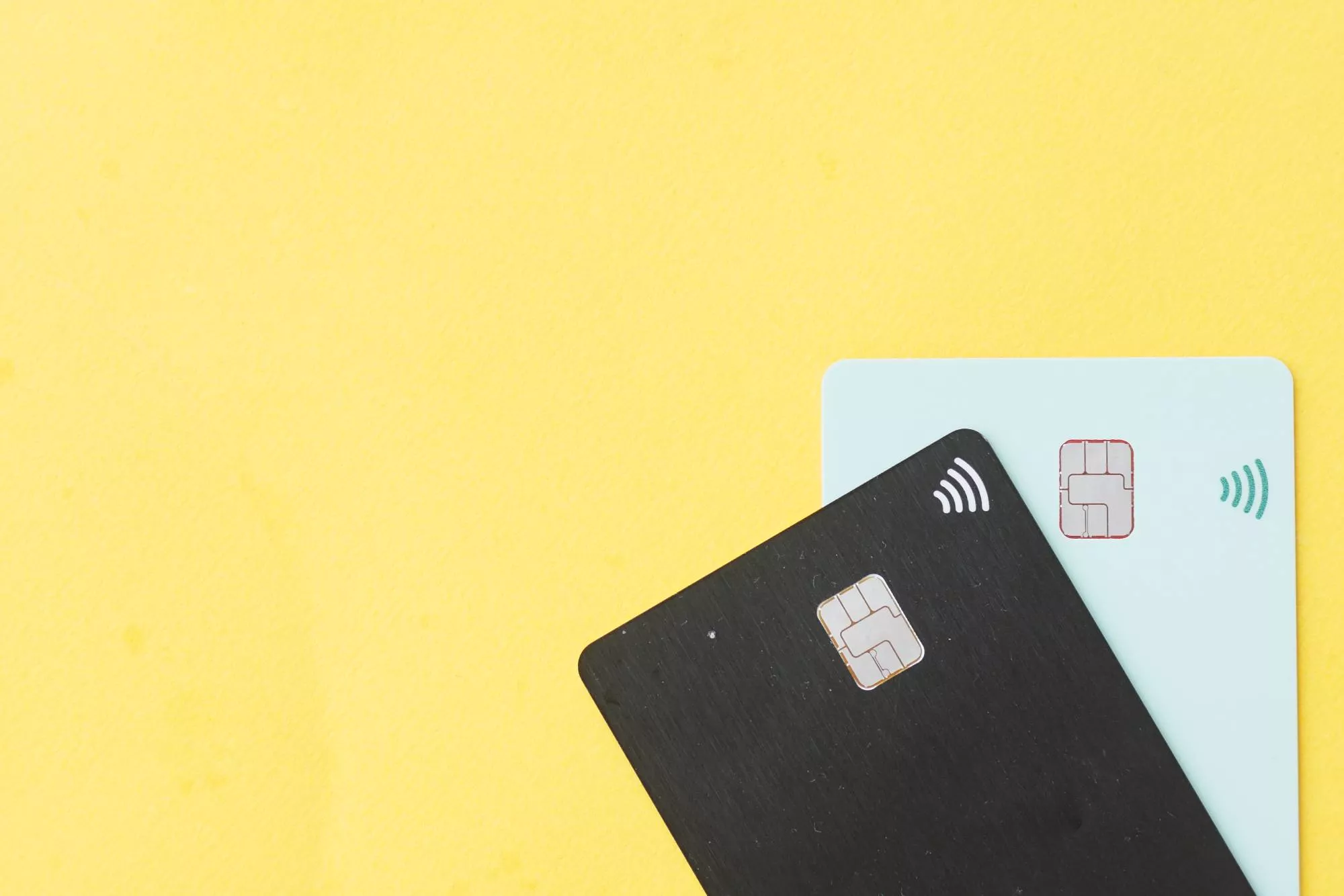 Credit cards on a yellow background ready to process after getting a merchant account.