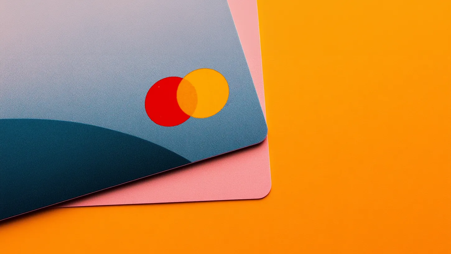 Close-up of layered credit cards in modern colors with the Mastercard logo prominent