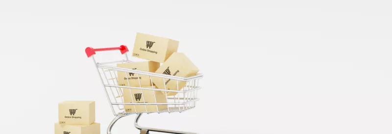 A shopping cart with boxes in it to represent authorize.net fees from online shopping.