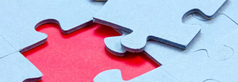 A puzzle piece fitting into a puzzle during a WooCommerce integration with Authorize.net.