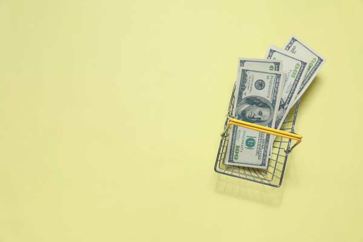 Hundred dollar bills on a yellow background