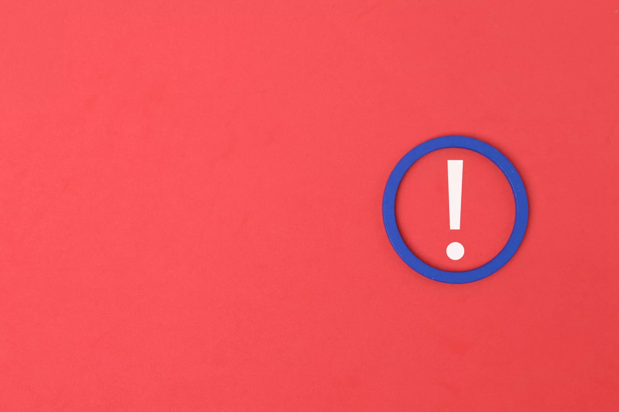 A white exclamation mark inside a purple circle on a red background to represent r83 ach return code.