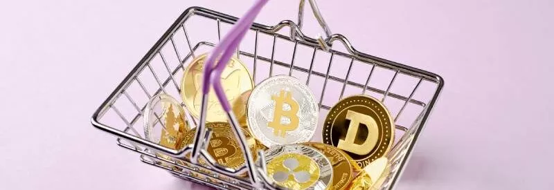 A basket full of cryptocurrency coins ready for a merchant who accepts crypto payments.