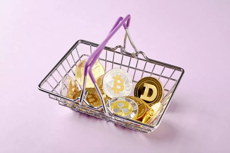 A basket full of cryptocurrency coins ready for a merchant who accepts crypto payments.