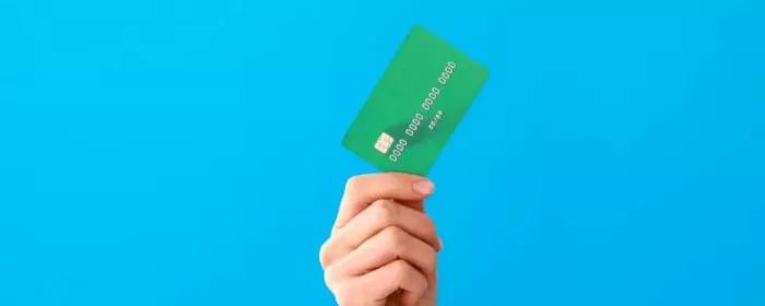 hand holding a green credit card