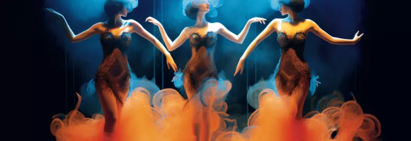 three burlesque style dancers on stage with smoke swirling around them as they dance sensually