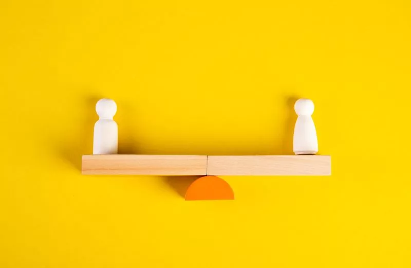 Stripe vs Adyen blocks on a scale with a yellow background.