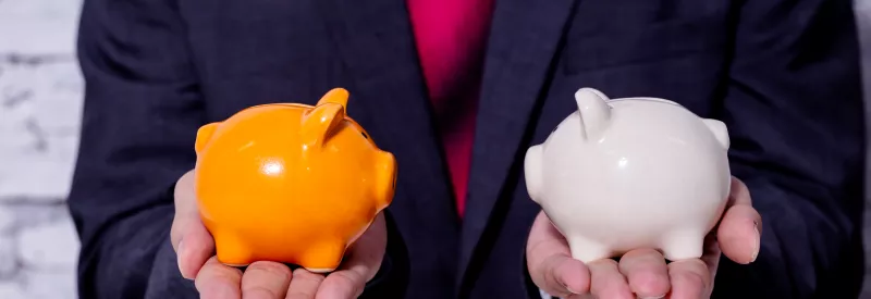 A business man holds two different piggy banks symbolizing woocommerce payments vs stripe