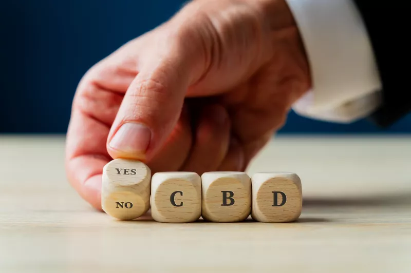 A merchant spelling out cbd with blocks after receiving a Illinois CBD license.