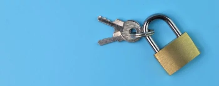 A lock and key for locbox banking on top of a baby blue background.