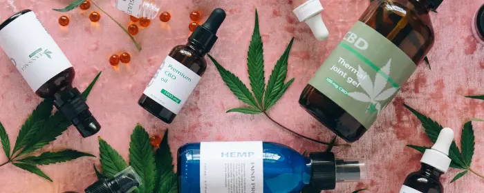 CBD products laid out on a pink table to be sold with a Hawaii CBD license.