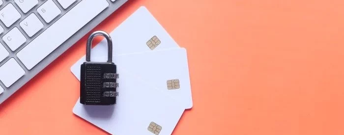 Cash app business scams deflected with a padlock on top of a stack of credit cards.