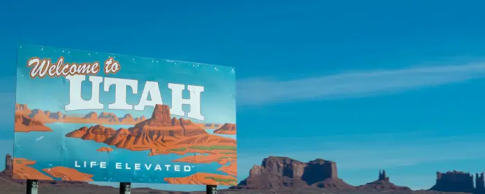 A sign that reads "Welcome to Utah, Life Elevated," where you can obtain a Utah FFL.