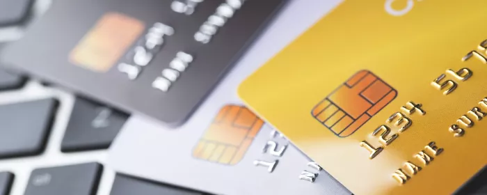 A stack of Visa and Mastercard credit cards.
