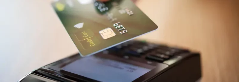 A credit card being used at a payment processing terminal